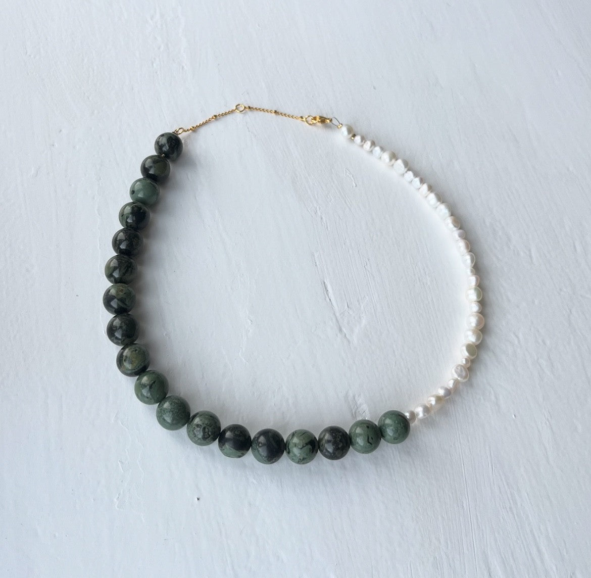 Necklace with large dark green beads and freshwater pearls