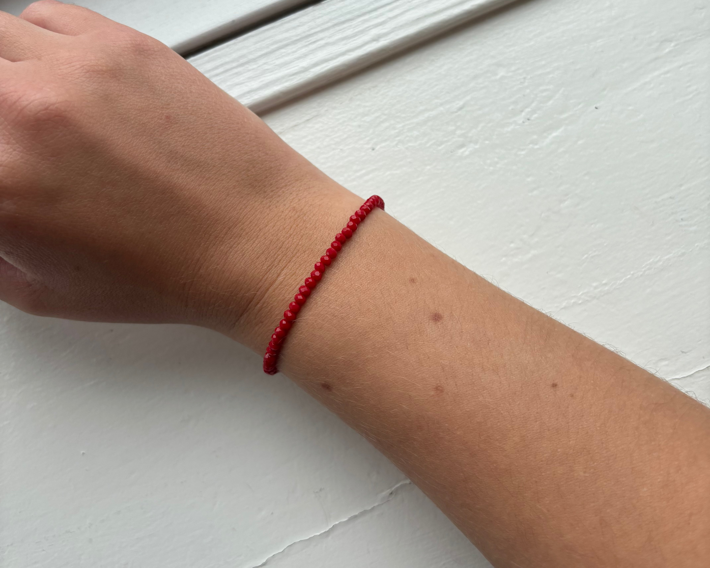 Bracelet with small red glass beads